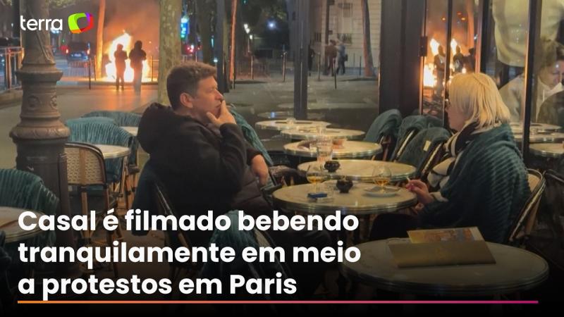 Casal é flagrado bebendo e conversando em meio a protestos em Paris